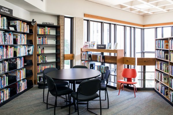 MERIT Library with black table and chairs surrounded by bookshelves.