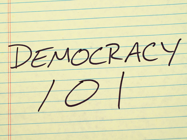 Yellow line paper with the words written, "Democracy 101"