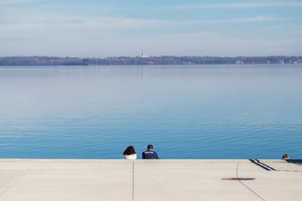 Two people looking out at Lake Mendota.